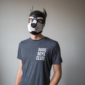 May include: A person wearing a black and white dog mask with the text "GOOD BOYS CLUB" on a dark grey t-shirt.