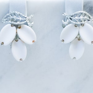 Vintage Lisner White Thermoset Clip Earrings With Silver Tone Filigree Leaf.