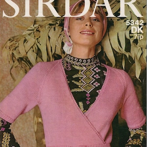 May include: A pink wrap cardigan with a self-tie belt. The cardigan has a V-neck and short sleeves. The model is wearing a patterned top underneath. The image includes the text "5342 DK 7p".