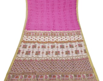 May include: A bright pink textile with a patterned design. The fabric features a detailed border with floral and geometric patterns in shades of pink, brown, and white. The textile has a gold trim.