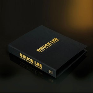 May include: A black hardback book with gold lettering titled "Bruce Lee: The Life, The Legacy, The Legend".