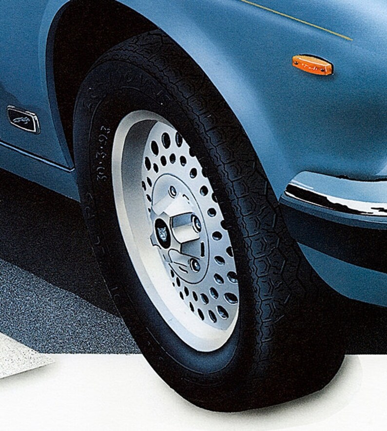 May include: Close-up of a silver and black car wheel with a tire that says "205/70 ZR 15".