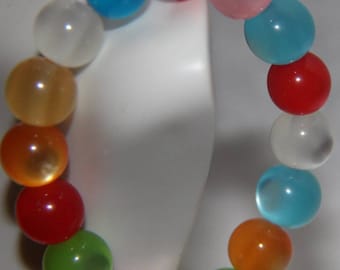 Light colored rainbow bracelet.