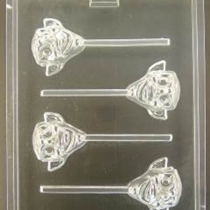 May include: A clear plastic mold for making chocolate lollipops. The mold has four cavities, each shaped like a cartoon face with a stick attached.