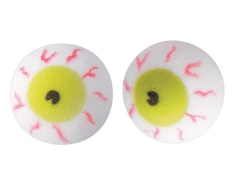 Puede incluir: Dos ojos de espuma blanca con venas rojas e iris amarillos. Los ojos tienen pupilas negras.