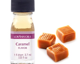 May include: A small glass bottle with a black cap filled with a clear liquid. The bottle label reads "LorAnn Oils Caramel Flavor 1 fl dram 3.7 ml .125 fl oz". Three caramel candies are shown in the background.