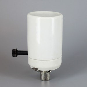 May include: White ceramic light socket with a black knob and a silver metal base.