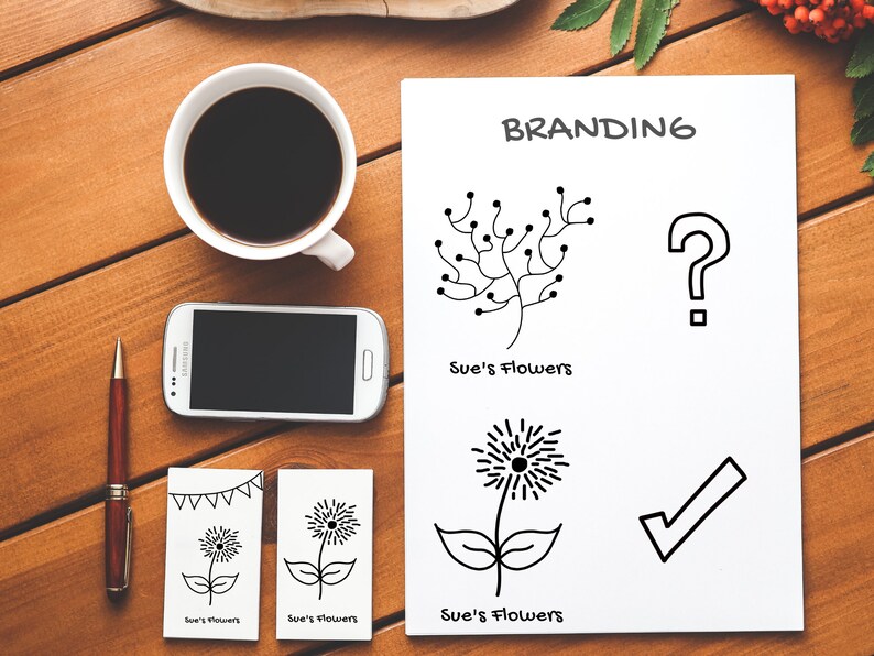 Op de afbeelding: Brandingconcept voor een bloemenwinkel genaamd "Sue's Flowers". Het ontwerp bevat een gestileerde bloem, een vraagteken, een vinkje en de tekst "Sue's Flowers" twee keer herhaald.