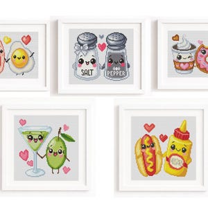 May include: Five framed cross-stitch artworks featuring food-themed characters. The images include bacon and egg, salt and pepper shakers, a coffee and donut, a martini and olive, and a hot dog and mustard, all with smiling faces and hearts.