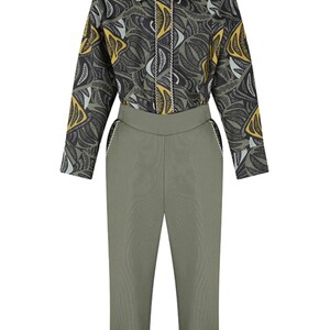 May include: A green and black patterned long-sleeve shirt with a collared neckline and a button closure. The shirt is paired with matching green pants that have a cuffed hem.