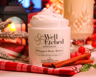 May include: A white jar of whipped body butter with a red and white plaid fabric and cinnamon sticks. The jar is labeled "Well Etched" and "Whipped Body Butter". The jar is 8 oz.