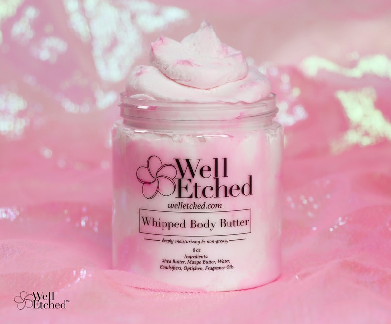 May include: A pink jar of whipped body butter with the brand name "Well Etched" and the text "Whipped Body Butter - deeply moisturizing & non-greasy - 8 oz. Ingredients: Shea Butter, Mango Butter, Water, Emulsifiers, Optiphen, Fragrance Oils" on the label.
