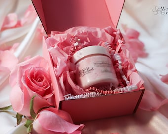 May include: A pink gift box with a white and pink tissue paper filler. The box contains a white jar of whipped body butter with the text "Well Etched" and "Whipped Body Butter" on the label.