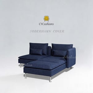 May include: A modern, modular sofa in a deep navy blue fabric. The sofa features a chaise lounge and two large back cushions, with smaller accent pillows. The sofa has silver metal legs and the text "CYCushions SÖDERHAMN COVER" is visible.
