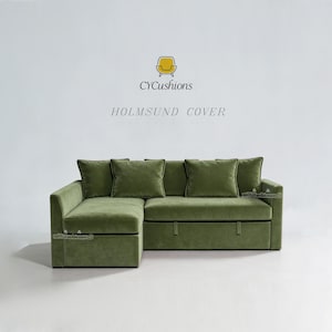 May include: A sage green velvet sectional sofa cover featuring a chaise lounge section on the left and a pull-out bed base. The text CYCushions and HOLMSUND COVER appears above the sofa. The fabric has a soft texture and uniform color.