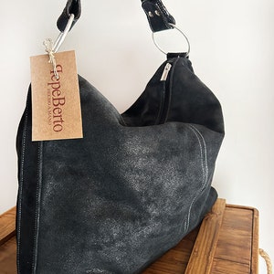 Black shiny suede women&#39;s bag. Roomy and light daily bag with zipper closure.