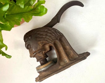 Lot - Antique hand crank food chopper and cast iron figural lion embossed  seal press.
