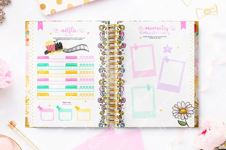 May include: Open notebook with a gold spiral binding, featuring colorful pages for planning. One page has a Netflix theme with a popcorn graphic and film strip. The other page has photo frames and a daisy.