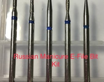 May include: Set of five silver nail drill bits with blue bands. The bits are arranged in a row in a clear plastic case. The text "Russian Manicure E-File Bit Kit" is printed in red on the case.