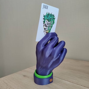 Joker hand with actual size card