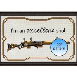 Peut inclure: Motif de point de croix encadré en noir. Le design présente un fusil avec des accents dorés et bleus, et le texte "I'm an excellent shot." Un cercle bleu avec "pdf pattern" est également inclus.