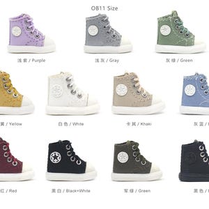 May include: Ten pairs of miniature canvas sneakers in various colors, including purple, gray, green, yellow, white, khaki, blue, red, black and white, and black. Each shoe has a star design on the side. OB11 Size is written at the top of the image.