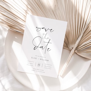 Peut inclure: Carte de "Save the date" avec un fond blanc et du texte noir. Le texte indique "save the date" en écriture cursive. La carte comprend également les noms "Elise + William", la date "26 août 2021" et le lieu "Melbourne, Victoria".