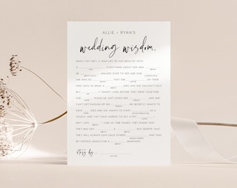 May include: A white wedding Mad Libs game card with black text. The card reads "Allie + Ryan's wedding wisdom." The fill-in-the-blank story includes prompts for nouns, adjectives, and body parts. A fun activity for wedding guests.