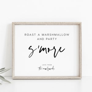 May include: A white framed sign with black text that reads "Roast a marshmallow and party s'more Love from the newlyweds".