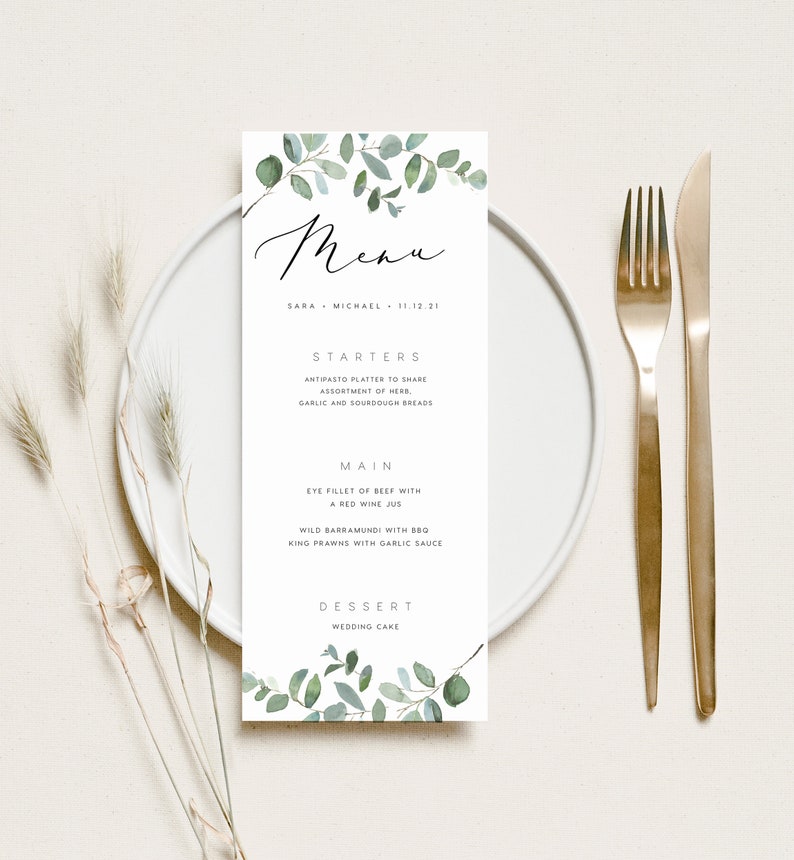 May include: A wedding menu with a green watercolor floral design. The menu lists starters, main course, and dessert. The text reads: "Menu", "Sara Michael 11.12.21", "Starters", "Antipasto platter to share, assortment of herb, garlic and sourdough breads", "Main", "Eye fillet of beef with a red wine jus", "Wild barramundi with BBQ king prawns with garlic sauce", "Dessert", "Wedding cake".