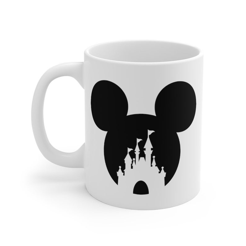 May include: White ceramic mug with a black silhouette of Mickey Mouse's ears with a silhouette of Cinderella's castle inside the ears.