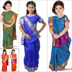 May include: Three young girls wearing different coloured saris. The saris are all traditional Indian style with gold trim. The girls are all smiling and looking at the camera.