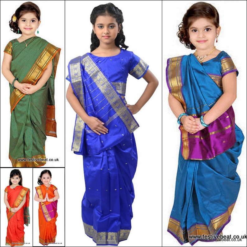 May include: Three young girls wearing different coloured saris. The saris are all traditional Indian style with gold trim. The girls are all smiling and looking at the camera.