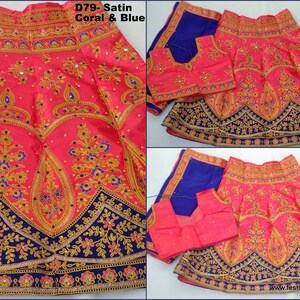 May include: A coral and blue satin lehenga with gold and blue embroidery. The lehenga has a blue border and a matching coral and blue blouse.