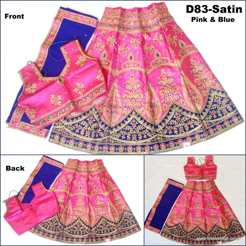 May include: A pink and blue Indian girls' lehenga choli set with gold embroidery. The skirt is pink with a blue and gold border. The choli is pink with gold embroidery. The dupatta is blue with a gold border. The set is called "D83-Satin Pink & Blue".