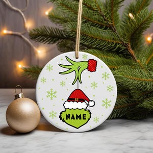 Digital PNG sublimation design for a custom family Christmas ornament, featuring personalized names on a round holiday template.