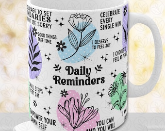 May include: White ceramic mug with a colorful design featuring flowers, stars, and inspirational quotes. The text includes "Daily Reminders", "Celebrate Every Single Win", "I Deserve to Feel Joy", "I Choose to Feel at Peace", "Courage to Set Boundaries", "Don't Be Sorry", "Good Things Take Time", "Small Steps Every Day", "Empower Your Damn Self", "You Can and You Will".