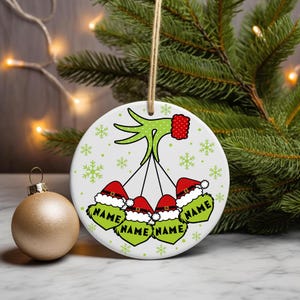 Digital PNG sublimation design for a custom family Christmas ornament, featuring personalized names on a round holiday template.