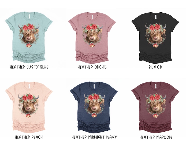 K&ouml;nnte beinhalten: Eine Auswahl an melierten T-Shirts in verschiedenen Farben, jeweils mit einer detaillierten Illustration einer Highland-Kuh mit Blumenkranz. Verf&uuml;gbare Farben sind Heather Dusty Blue, Orchid, Schwarz, Peach, Midnight Navy und Maroon.