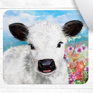 May include: A white calf with black ears and blue eyes looks directly at the viewer. The calf is surrounded by colorful flowers, including pink, purple, and red.