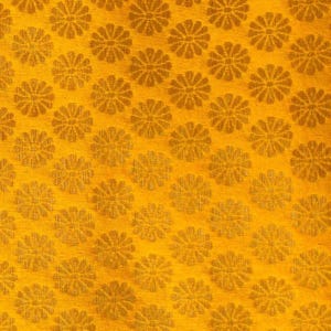 May include: A vibrant golden-yellow fabric featuring a repeating pattern of small, stylised floral motifs. Each flower consists of multiple thin, radiating petals arranged in a circular shape, creating a consistent and dense geometric texture.