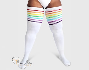 May include: White thigh-high socks with rainbow stripes at the top. The socks feature bands of red, orange, yellow, green, blue, and purple. The socks are made of a soft, comfortable material.