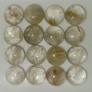 May include: A collection of 16 round, clear, cabochon cut, gold rutilated quartz gemstones. The stones have a translucent appearance with visible gold inclusions.