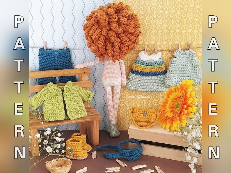 May include: A crocheted doll with red hair, wearing a variety of crocheted clothing, including a green jacket, blue jeans, and two dresses. The doll is sitting on a wooden bench with a small flower arrangement and a crocheted bag.