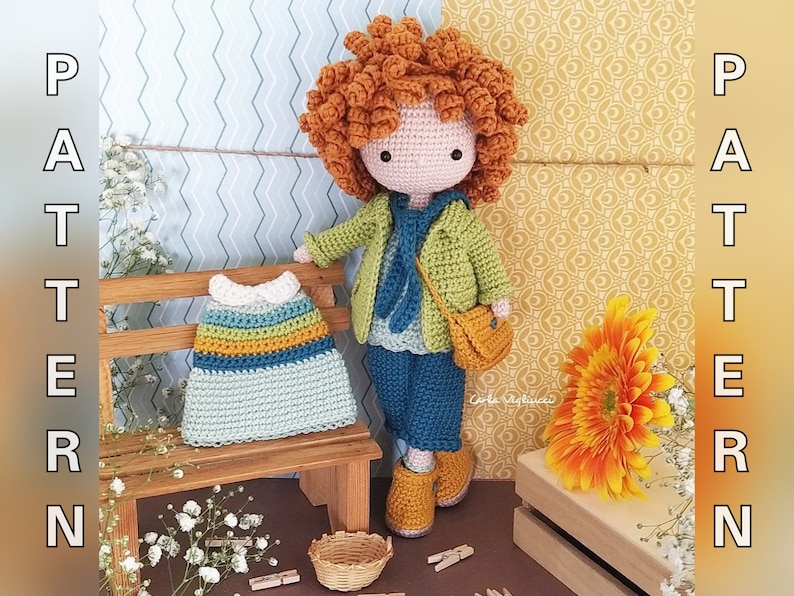 May include: Crocheted doll with red curly hair wearing a green jacket, blue jeans, and brown shoes. The doll is holding a small brown bag. The doll is sitting on a wooden bench with a crocheted dress on the bench. The background is a yellow and white patterned wall.