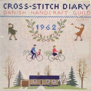 May include: Cross-stitch diary cover featuring a 1962 date, a wreath, and a family riding bicycles in front of a house. The text "Cross-Stitch Diary" and "Danish Handcraft Guild" is also included.