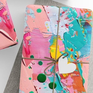 May include: Gift-wrapped presents with colorful abstract art paper, tied with twine and adorned with white star and heart tags. A ball of twine, scissors, and blank tags complete the scene, perfect for a creative gift-giving occasion.