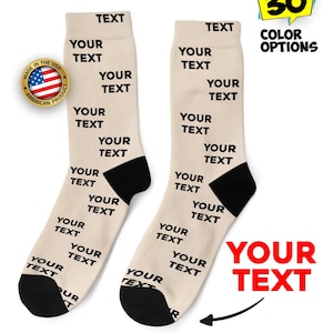 May include: Pair of beige socks with black heels and toes, featuring the text "YOUR TEXT" repeated multiple times. The socks have the text "TEXT" at the top. The image also includes a "Made in the USA" badge and a "30 COLOR OPTIONS" graphic.