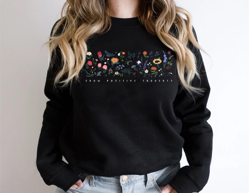 May include: Black sweatshirt with a floral design and the text "Grow Positive Thoughts".