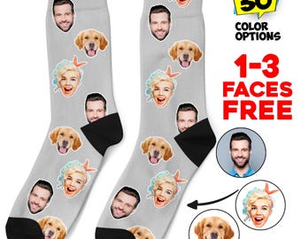 May include: A pair of gray socks with a black cuff. The socks feature a repeating pattern of faces and golden retriever dogs. The text "30 Color Options" and "1-3 Faces Free" is visible in the image.
